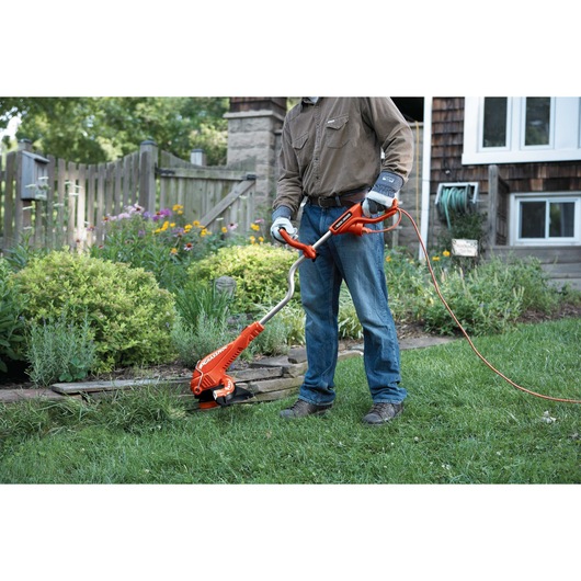 14 Inch Edger  being used by person to cut grass.