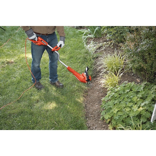 14 Inch Edger being used for trimming garden edges.