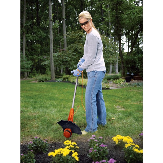 4.4 AMP 13 inch 2 in 1 Trimmer Edger being used by person in a garden.